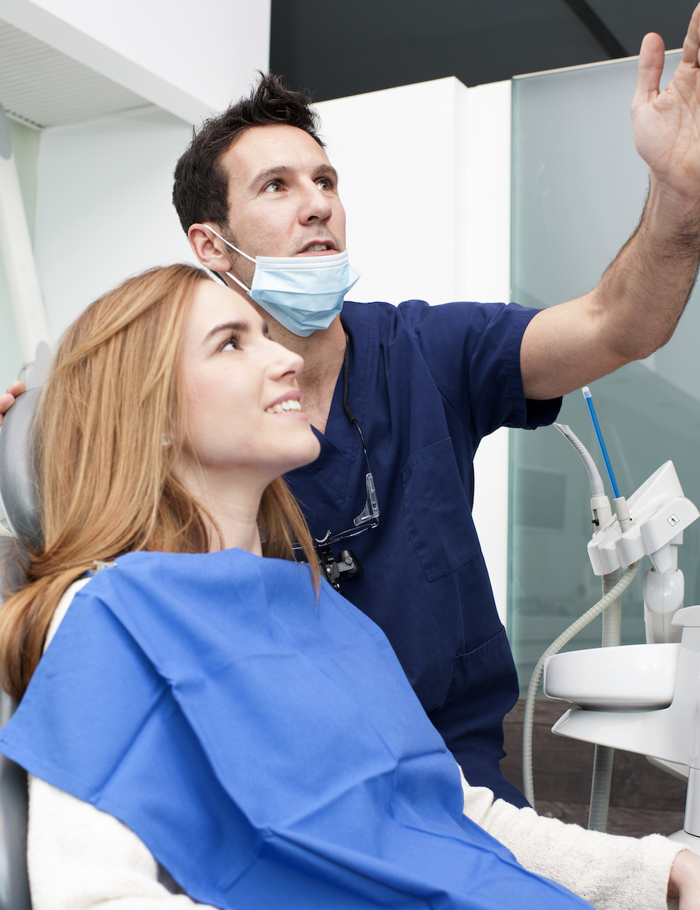 dentist showing female patient xrays
